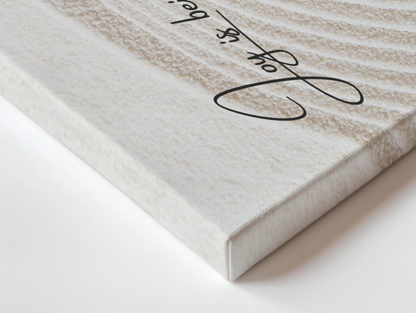 a close up of a white canvas with a signature on it