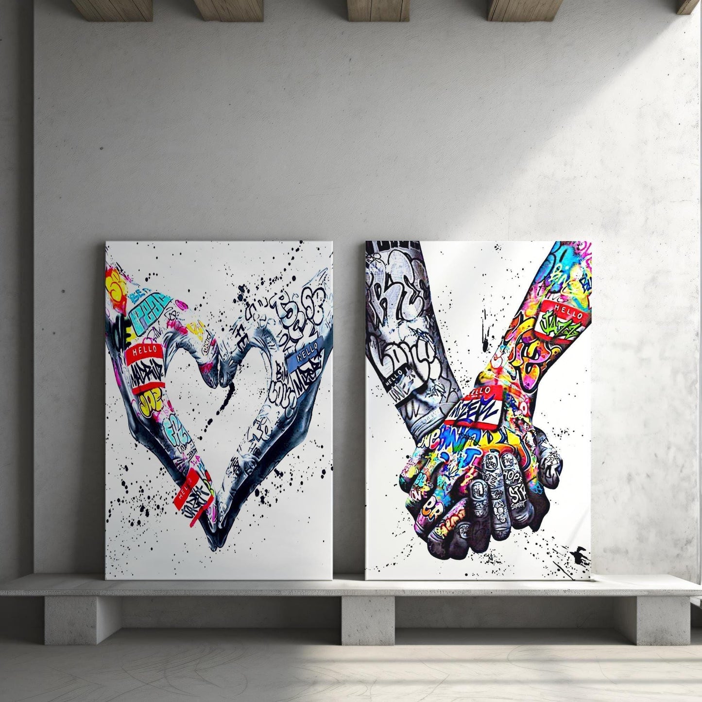 A powerful set of 2 graffiti prints symbolising world unity and connection through bold, expressive street art. One printed heart canvas features hands forming a heart shape, while the other showcases holding hands, both adorned with vibrant graffiti