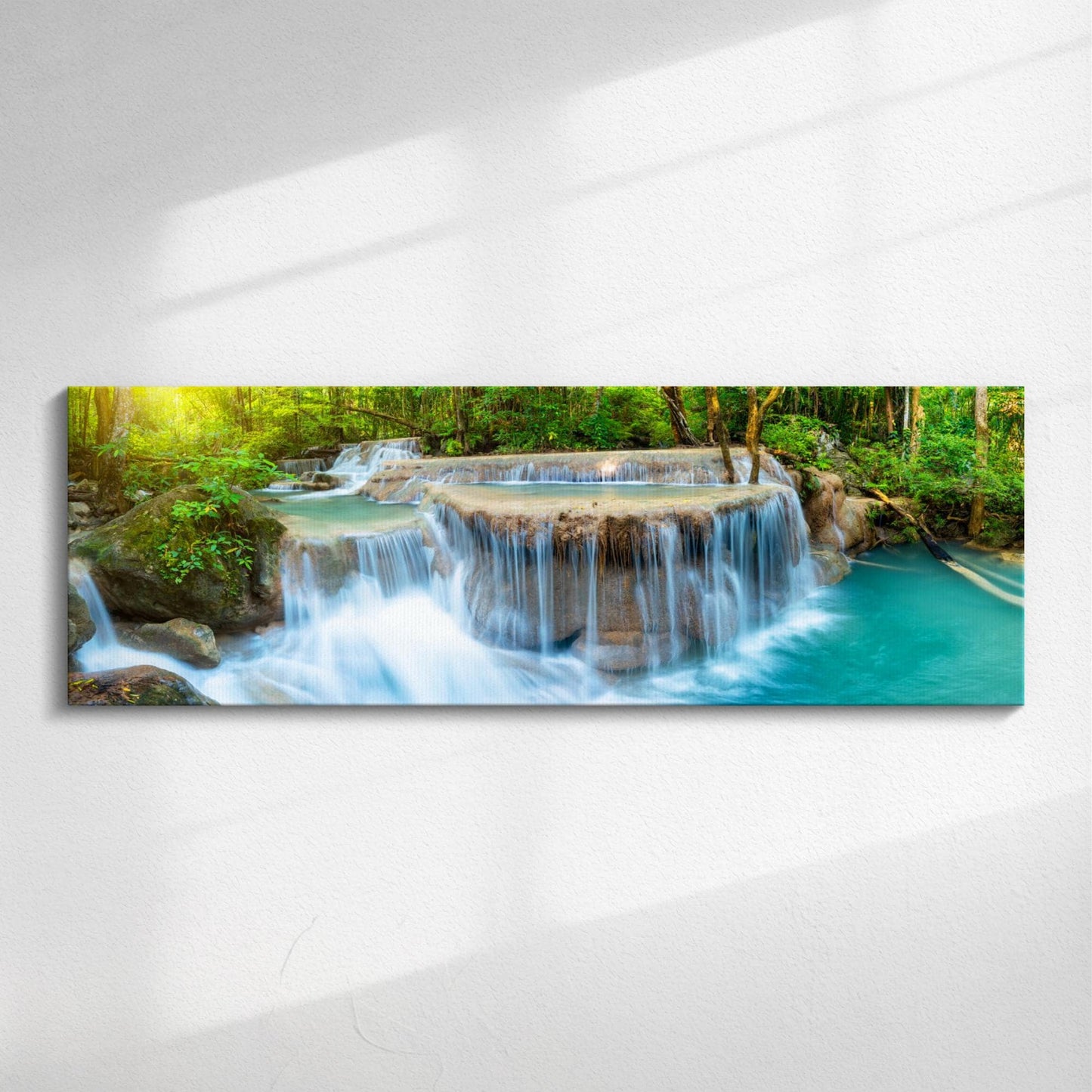 Panoramic canvas print of a forest waterfall with a flowing river surrounded by green woodland and mossy rocks