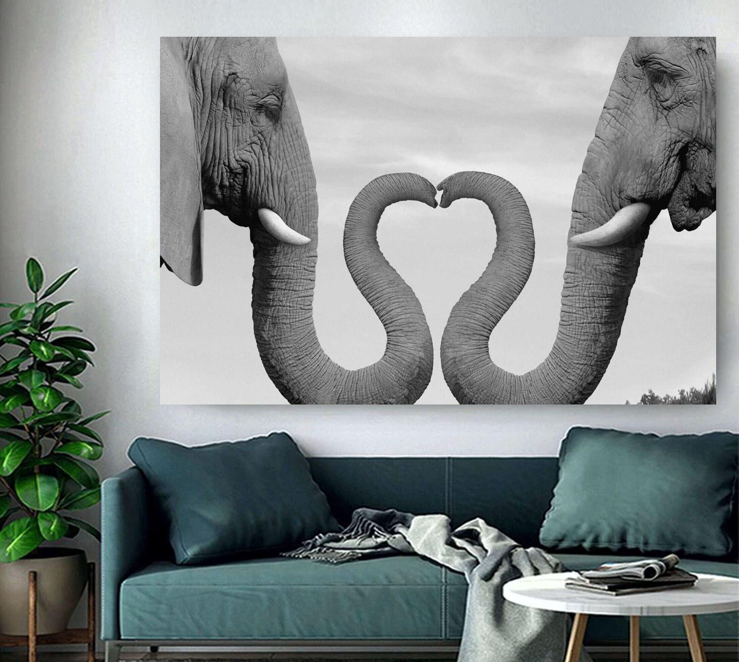 2 Elephant heads facing each other and their trunks making the shape of a heart, white background