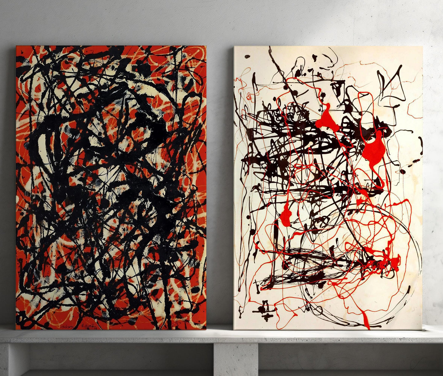 a couple of paintings sitting on top of a white shelf