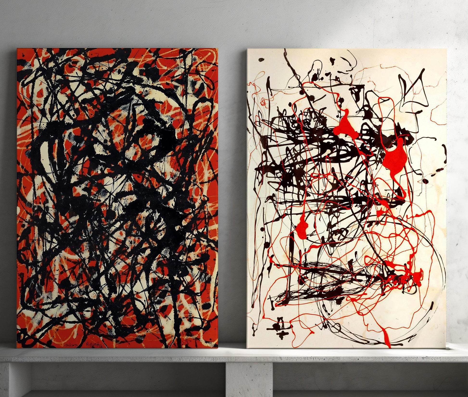 a couple of paintings sitting on top of a white shelf