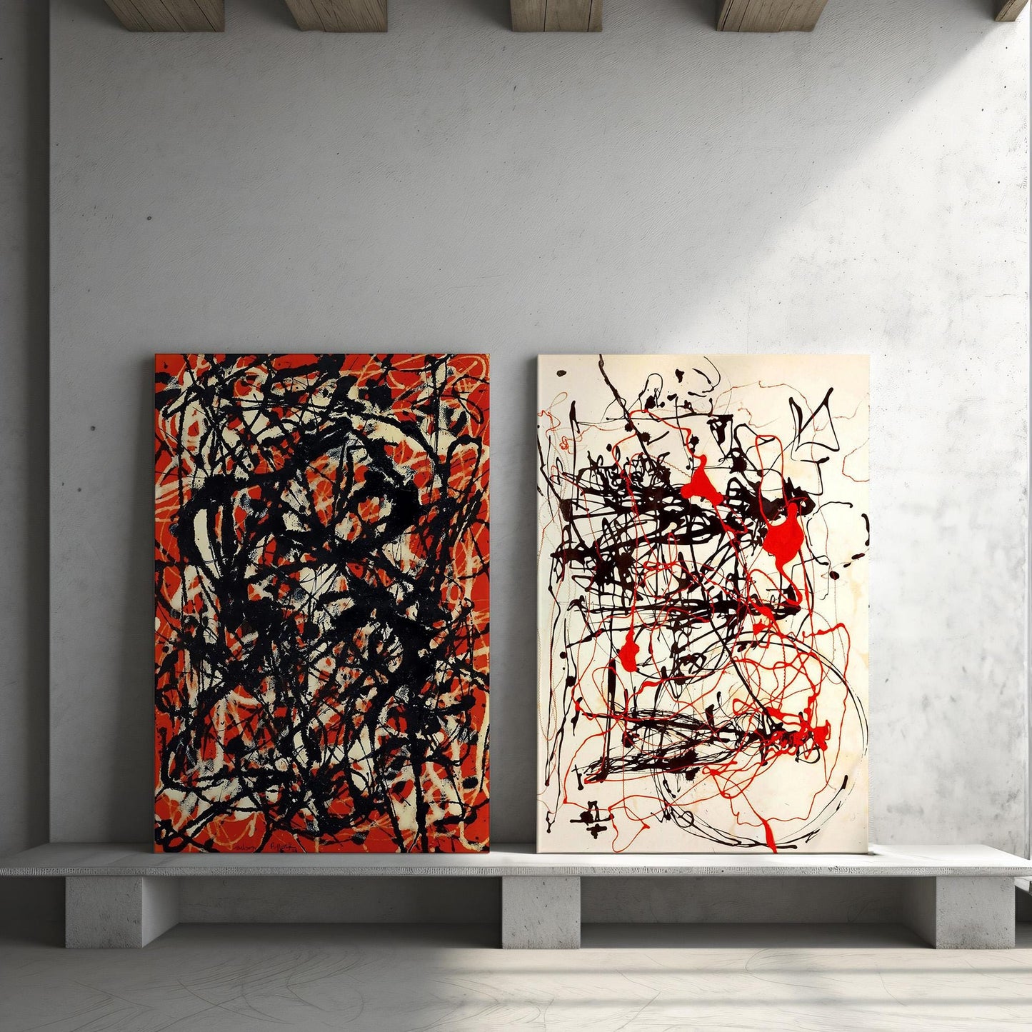 a couple of paintings sitting on top of a white shelf
