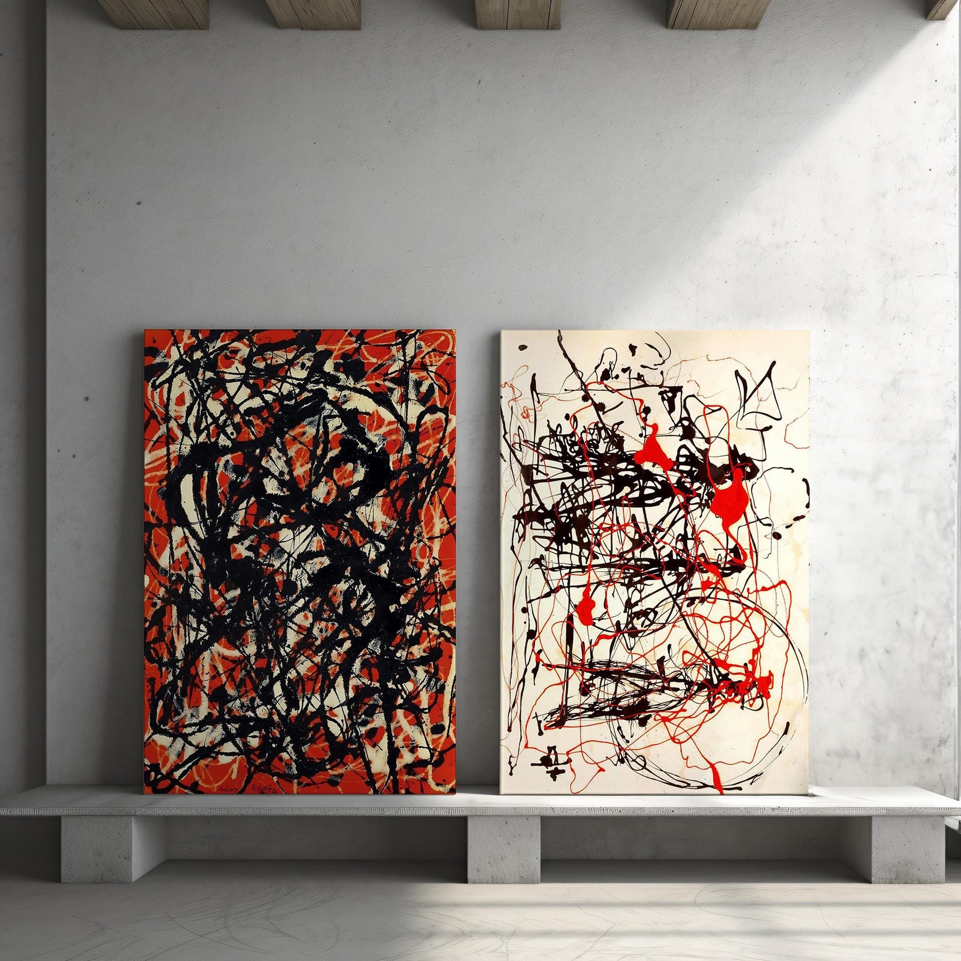 a couple of paintings sitting on top of a white shelf