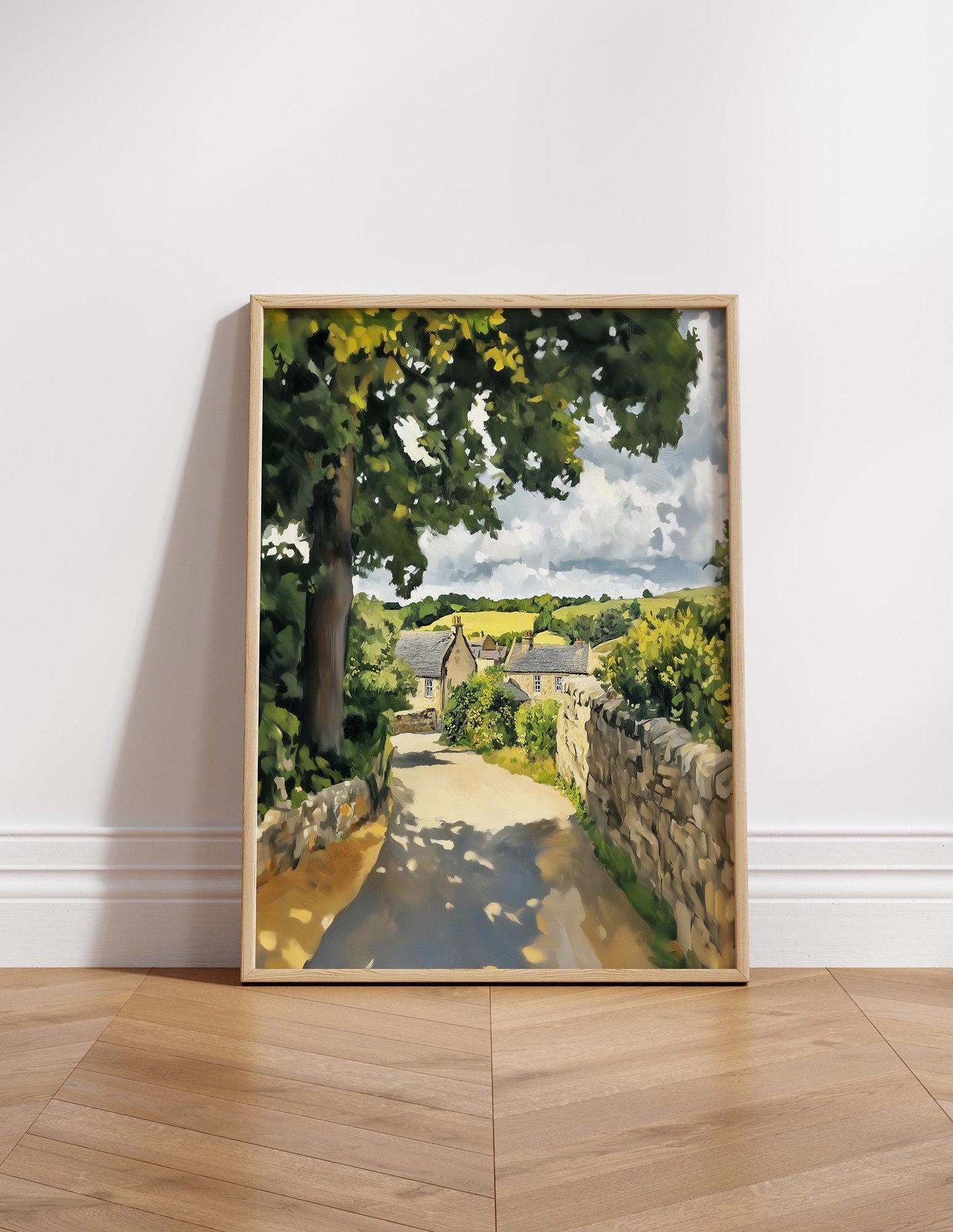 The image is a framed painting depicting a picturesque rural landscape with a winding dirt road, stone walls, and lush greenery.