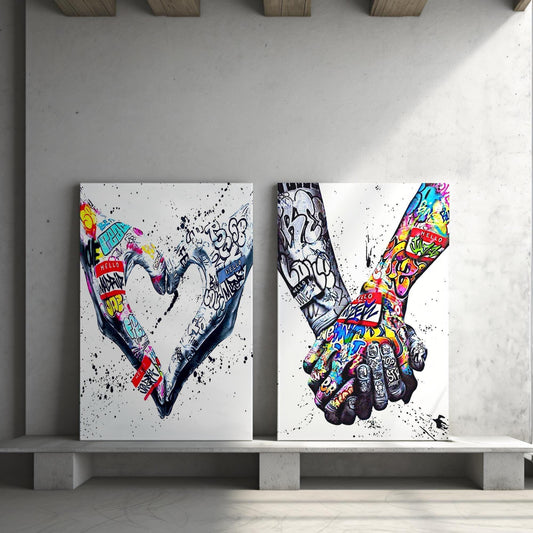 A powerful set of 2 graffiti prints symbolising world unity and connection through bold, expressive street art. One printed heart canvas features hands forming a heart shape, while the other showcases holding hands, both adorned with vibrant graffiti