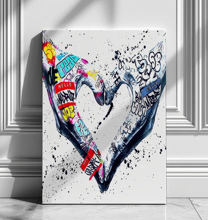 A powerful set of 2 graffiti prints symbolising world unity and connection through bold, expressive street art. One printed heart canvas features hands forming a heart shape, while the other showcases holding hands, both adorned with vibrant graffiti