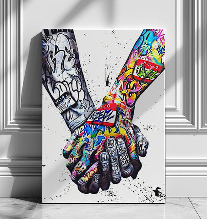 A powerful set of 2 graffiti prints symbolising world unity and connection through bold, expressive street art. One printed heart canvas features hands forming a heart shape, while the other showcases holding hands, both adorned with vibrant graffiti