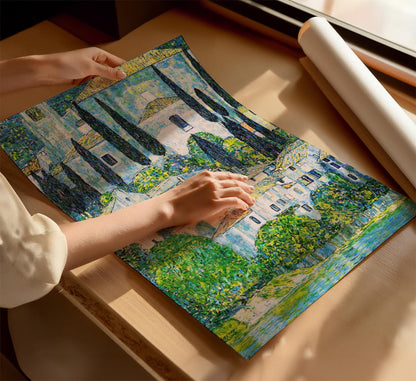 A person&#39;s hands are holding a large, colorful painting depicting a scenic landscape with trees and buildings.