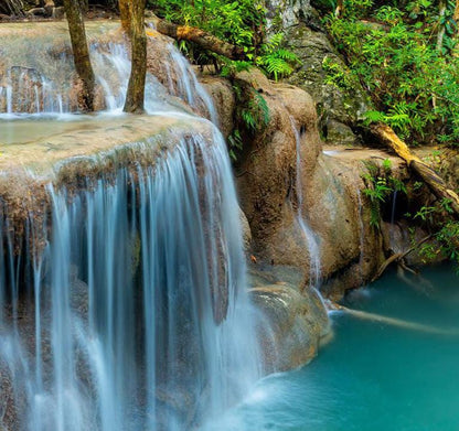 a waterfall in the middle of a pool of water
