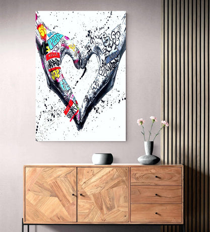 A powerful set of 2 graffiti prints symbolising world unity and connection through bold, expressive street art. One printed heart canvas features hands forming a heart shape, while the other showcases holding hands, both adorned with vibrant graffiti