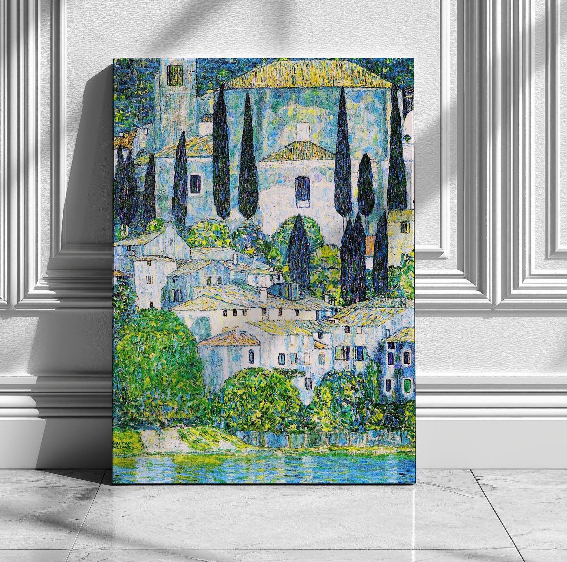 The image is a painting of a picturesque town with white buildings, green trees, and a body of water in the foreground.